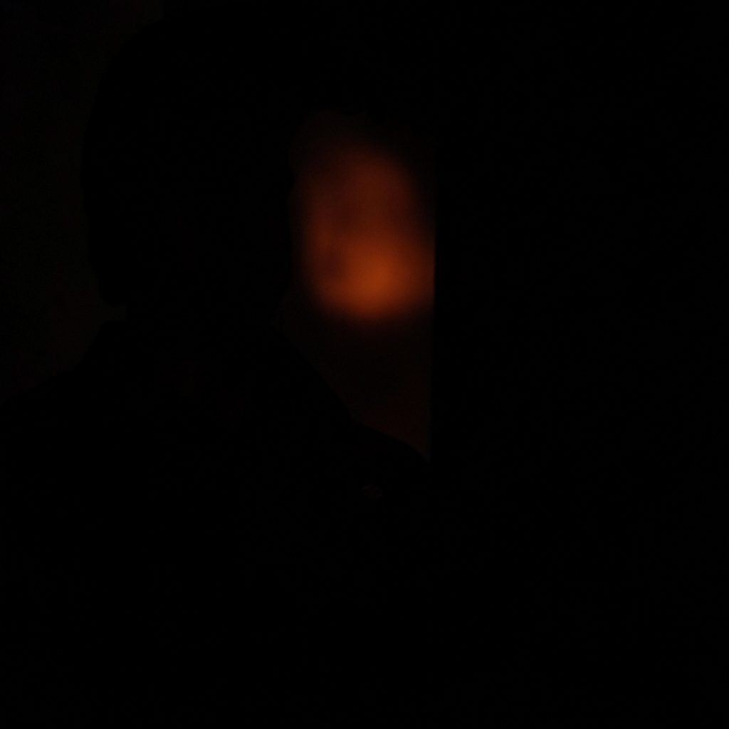 Dark, atmospheric image suggesting ambiguity, with soft blurred shapes fading into shadow